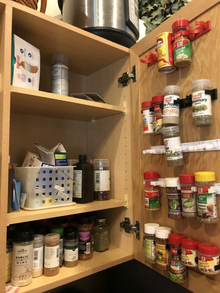 My messy cabinet and spice racks on the door