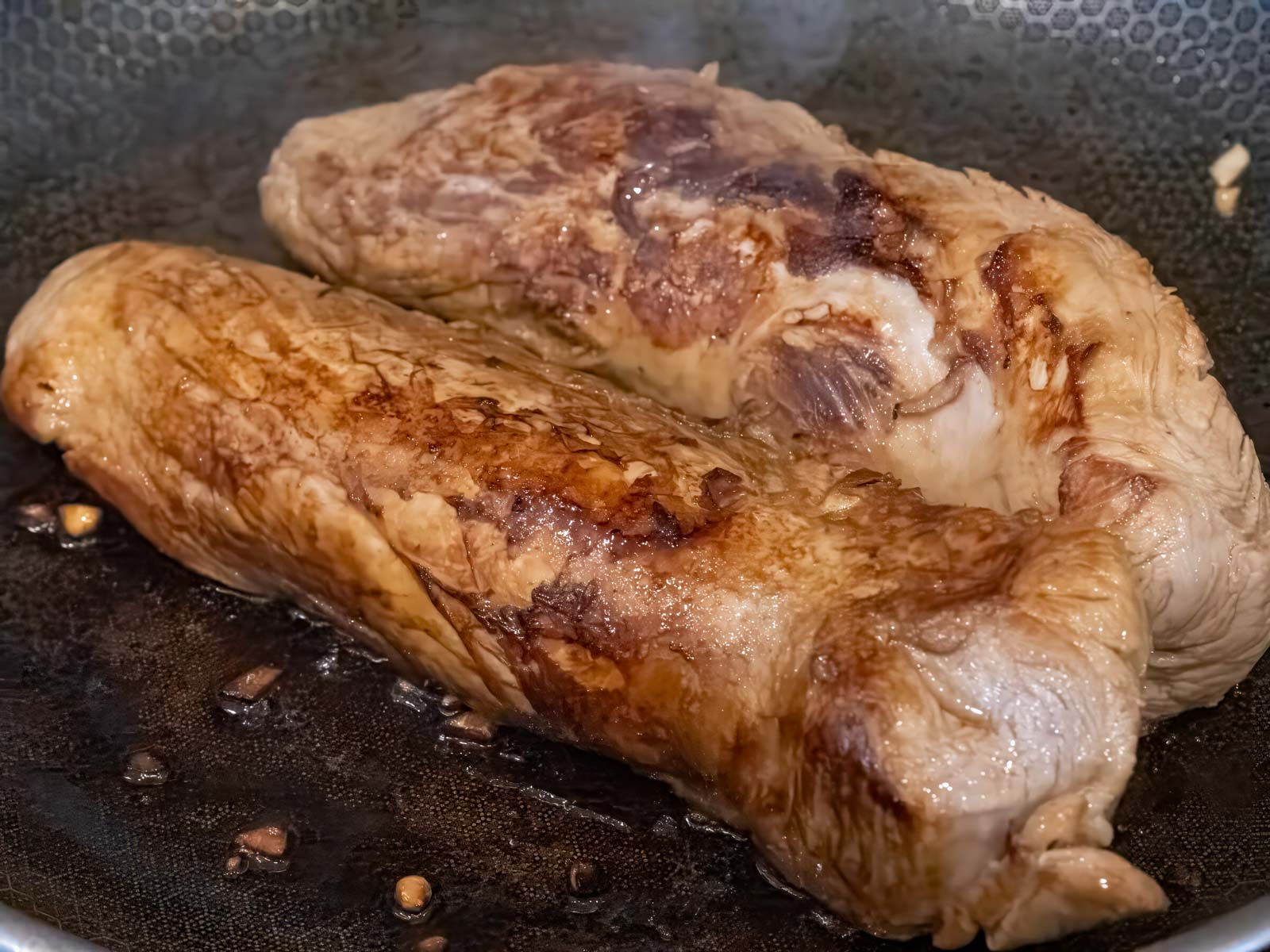 Pork being browned on the stove top