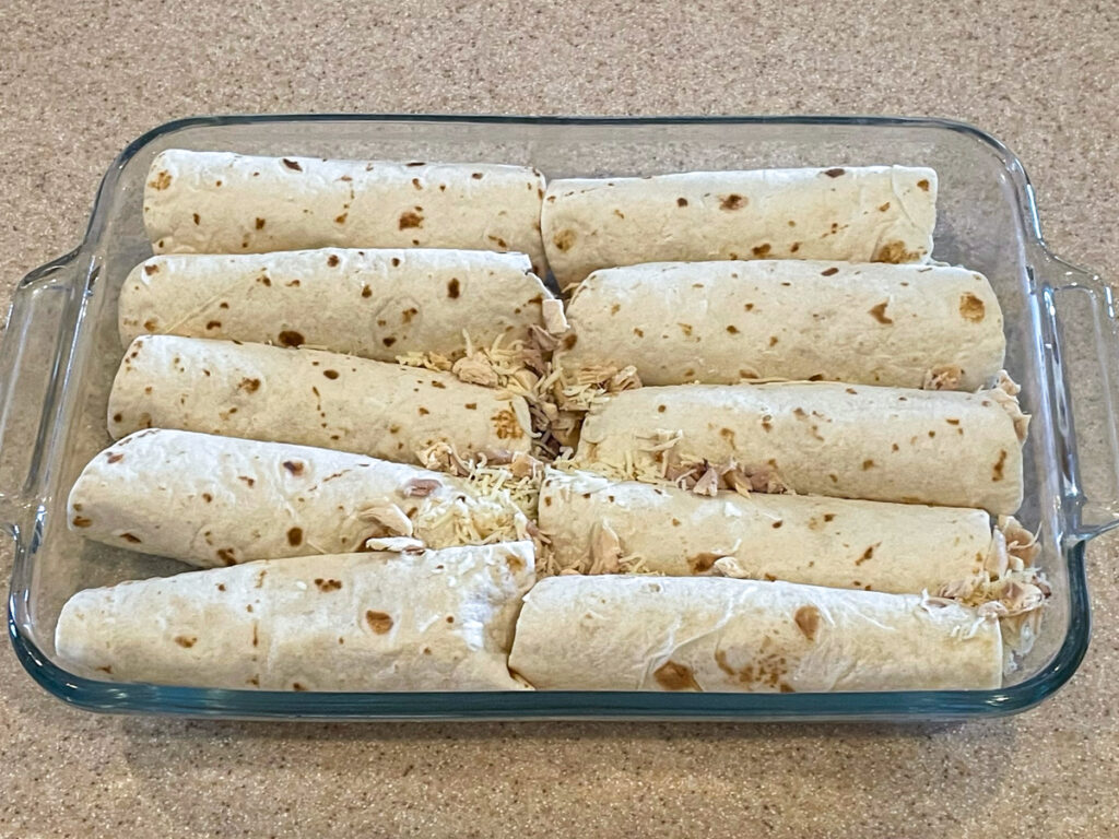 Enchiladas arranged in a baking dish before adding sauce