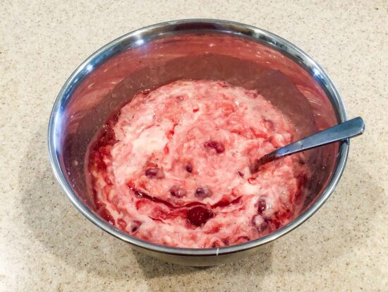 Step Photo - Combine Cherry Pie Filling, Pineapples, and Condensed Milk
