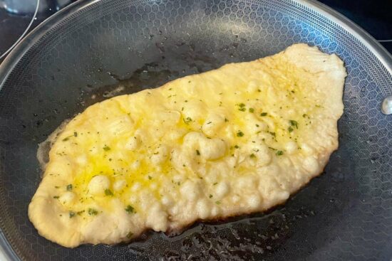 Naan bread while cooking