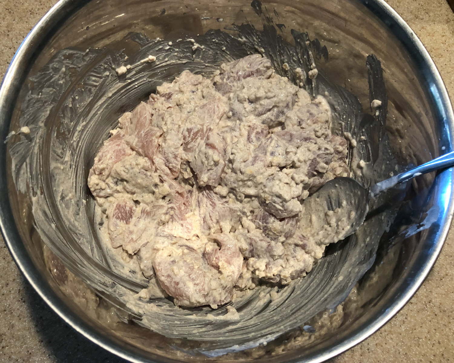 Chicken marinating in white korma sauce