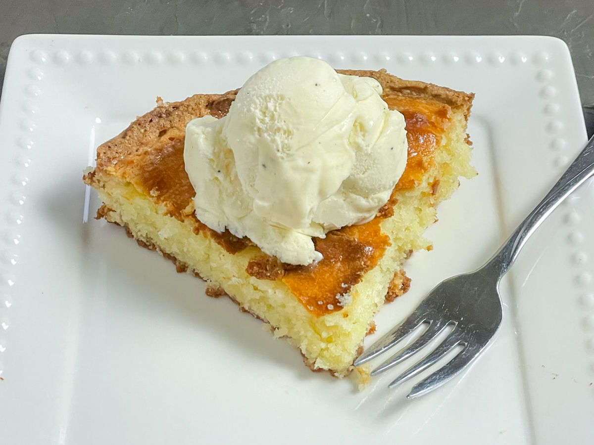 A slice of CPK Butter Cake served with vanilla ice cream