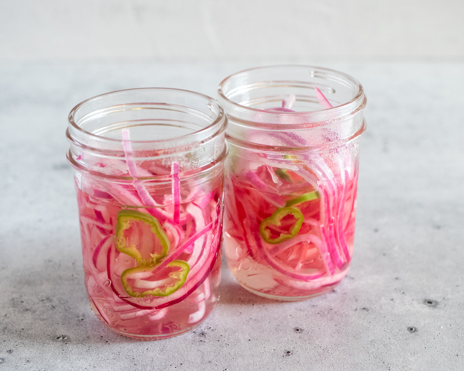 Mexican Pickled Red Onions in two mason jars