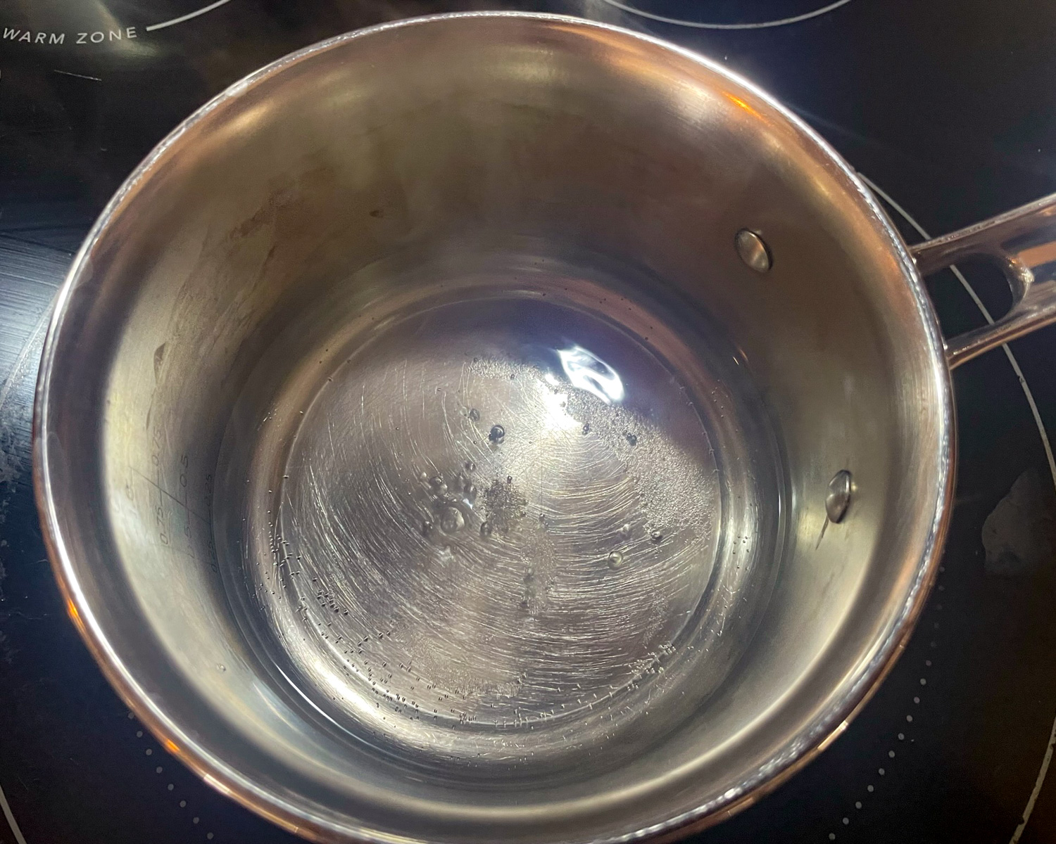 Water and vinegar in a pot starting to boil