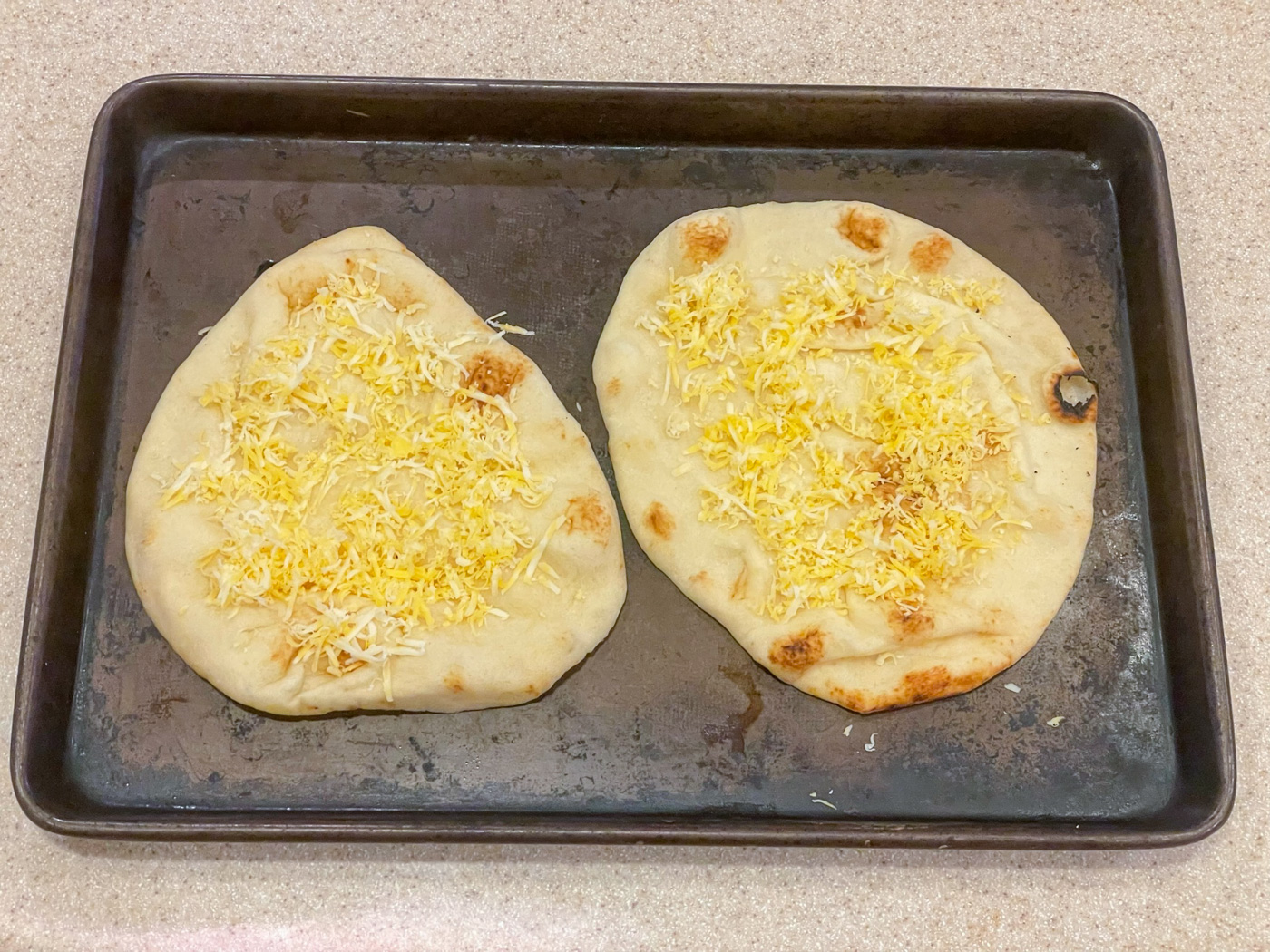 Flat bread sprinkled with Colby Jack cheese