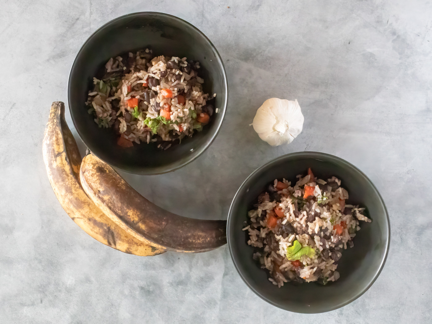 Gallo pinto, Costa Rican rice and beans, with fresh plaintains and a head of garlic