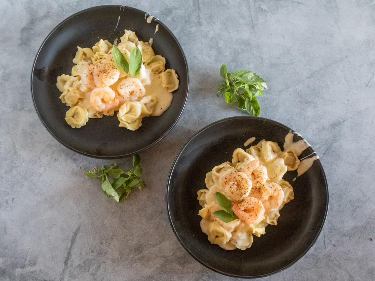 Two bowls of shrimp tortellini alfredo