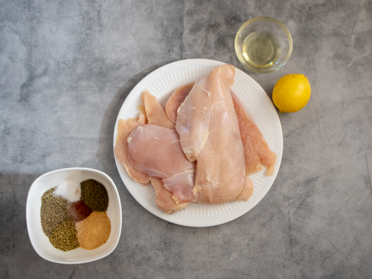 herb crusted chicken-ingredients arranged on grab background