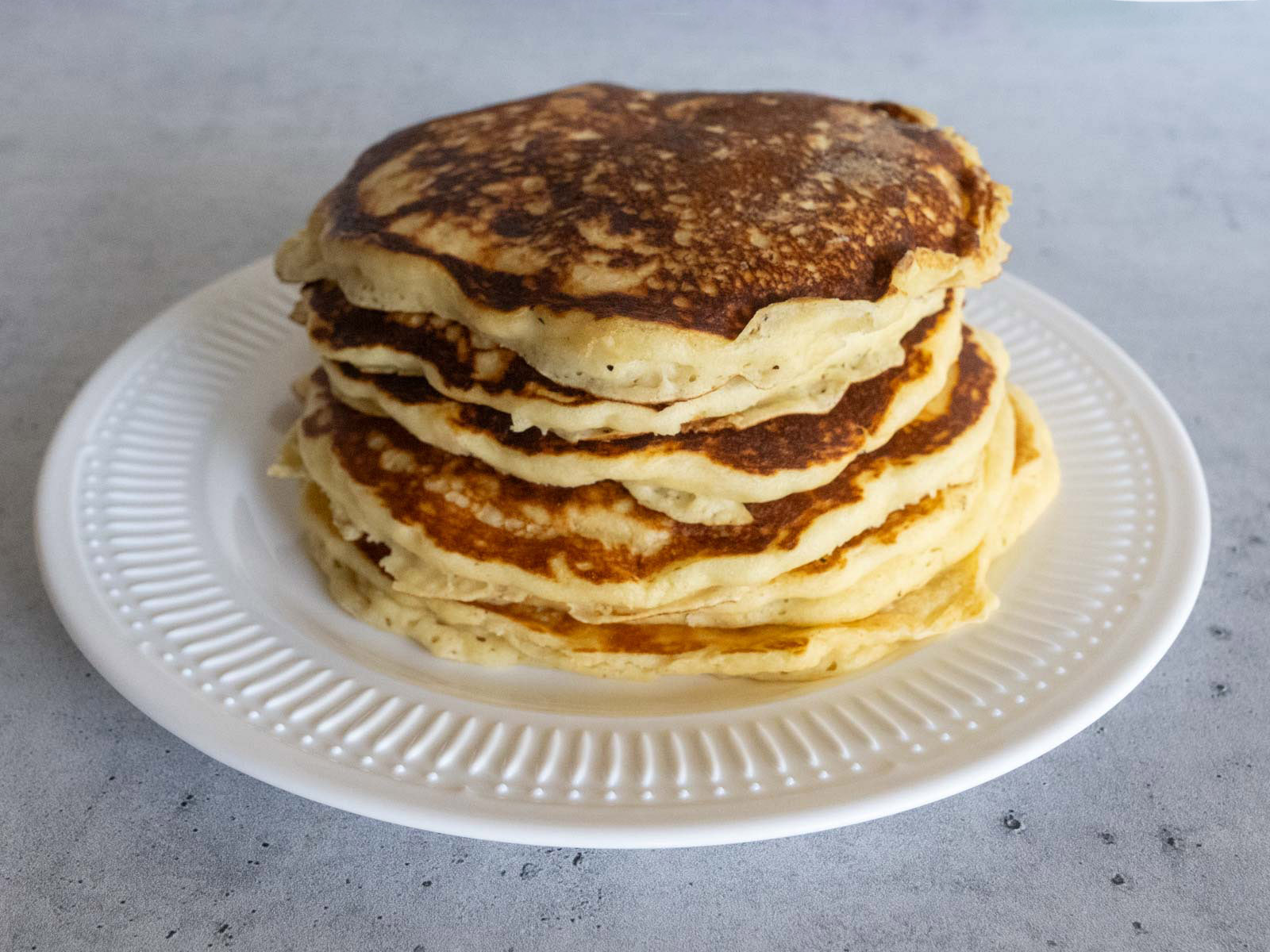 A stack of McDonald's hotcakes on a white plate