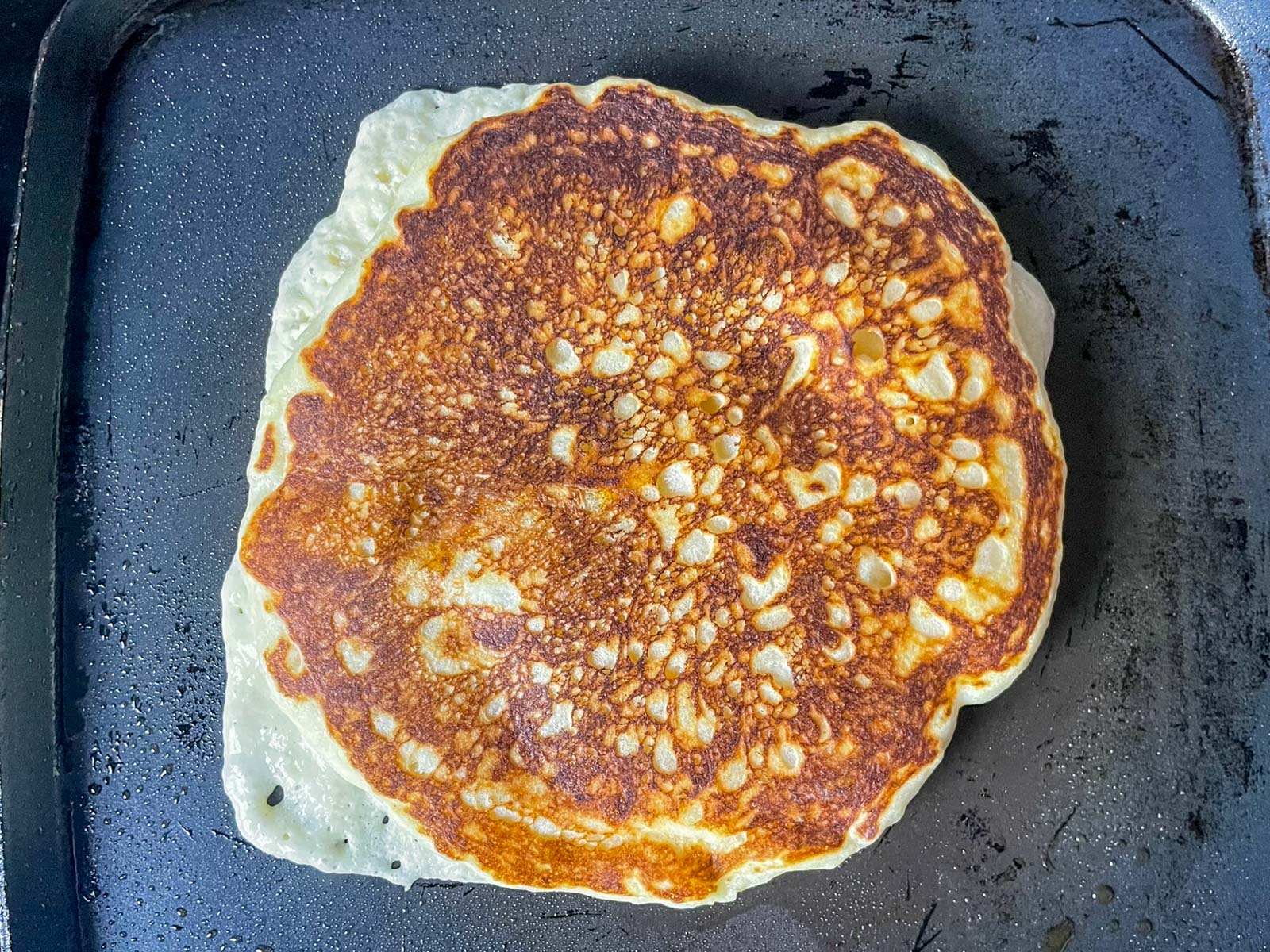 An almost-finished pancake on the griddle